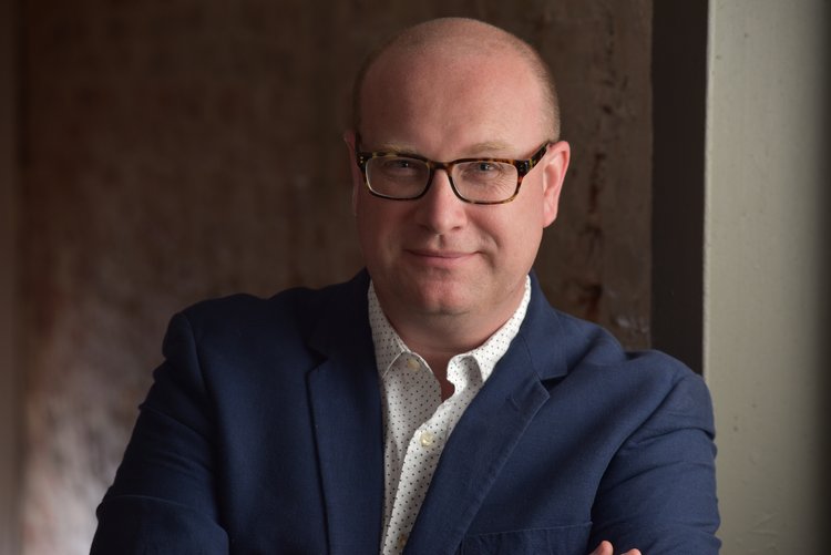 Jay Carter headshot white male bald glasses